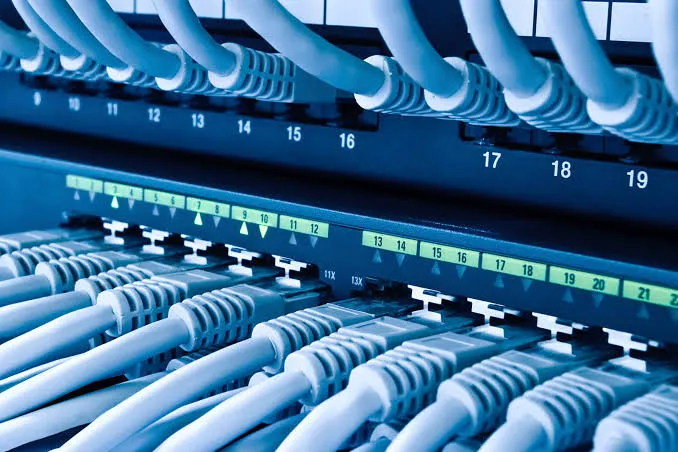 Numbered network patch panel with rows of ethernet cables neatly connected