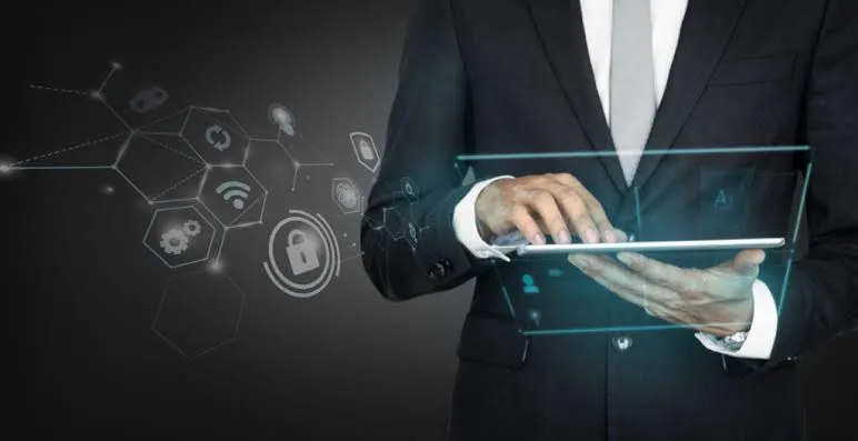 Homme d’affaires en costume utilisant une tablette transparente avec des icônes de sécurité et de réglages